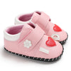 Pink baby shoes with heart and flower design