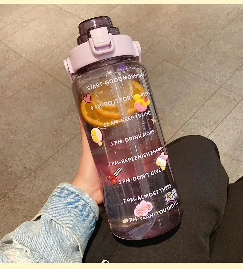 Purple 2L sports water bottle with straw, time marker, and fruit infuser, decorated with fun stickers for daily hydration and energy boost.
