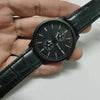 Black watch with textured dial and leather strap