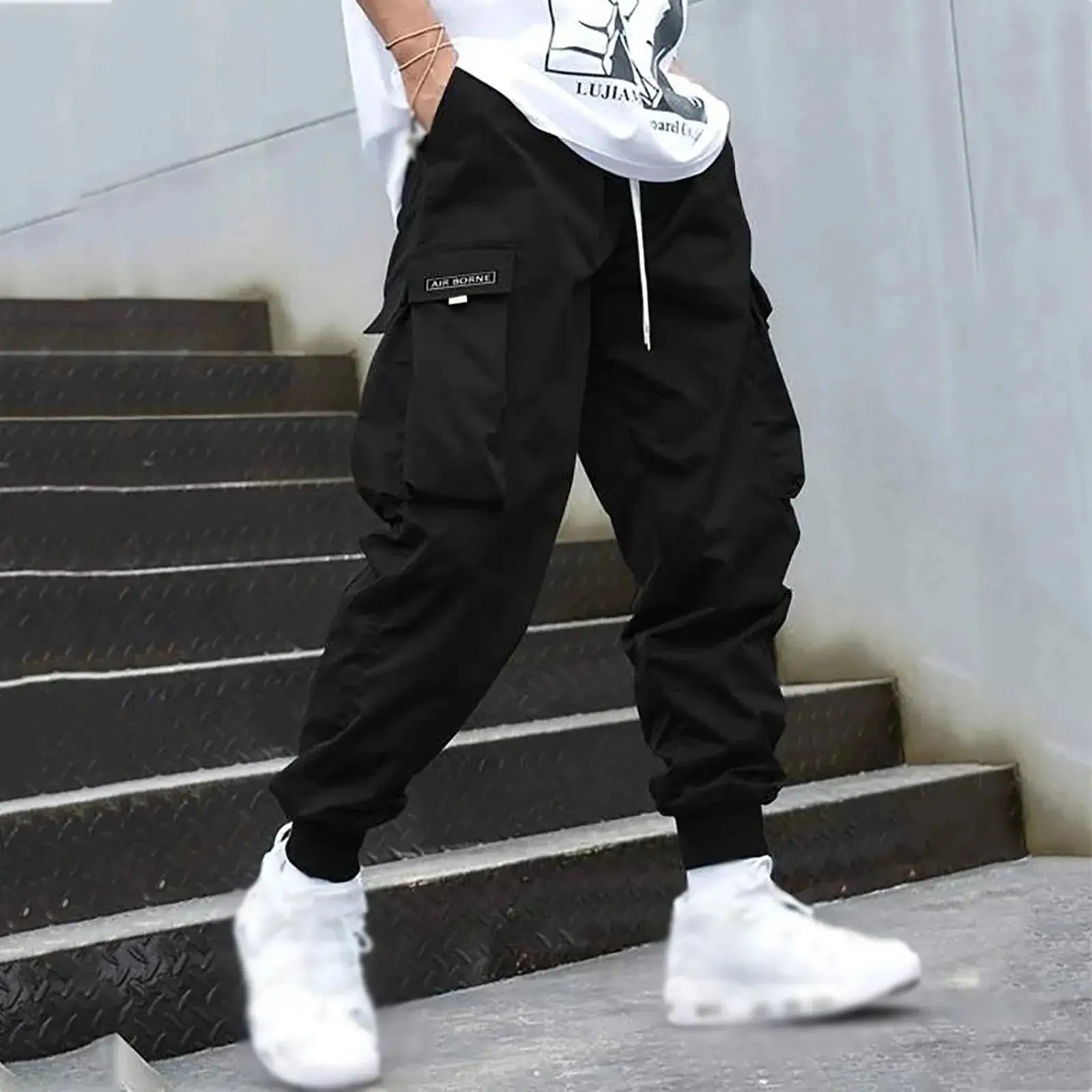 Black men’s sporty cargo jogger pants with drawstring and flap pockets, ideal for urban streetwear or everyday casual wear.