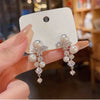 Pearl and crystal dangle earrings on display card