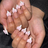 White French nails with pink bow embellishments