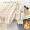 Cream thick winter sports pants for kids with drawstring and fleece lining.