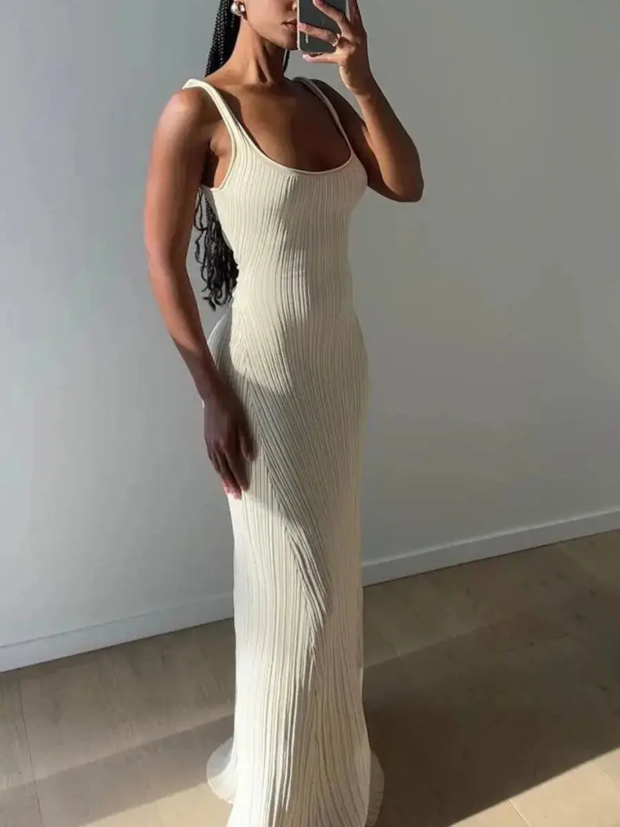 Side view of sleeveless U-neck cream knit tank dress for women, showcasing its flattering body-hugging silhouette and long length.