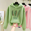 Green women's hoodie featuring feather print