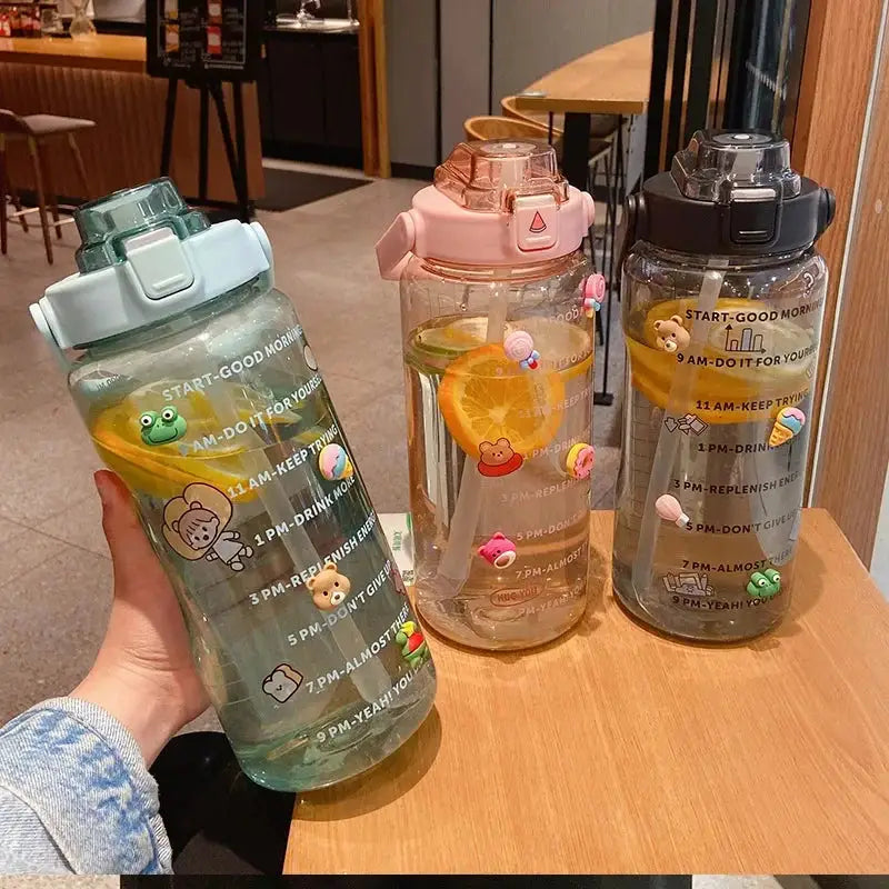 Set of 2L sports water bottles with straw and time marker, featuring cute stickers and motivational quotes for summer hydration and fitness tracking.