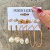 Gold and pearl earring set with geometric designs