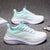 Mint green casual running shoes on gray surface