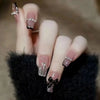 Elegant nails with black bows and glitter accents