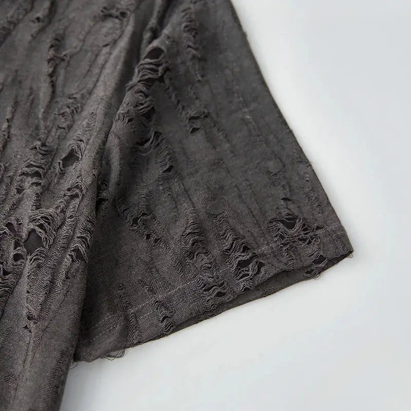 Sleeve detail of charcoal gray men’s short sleeve T-shirt with worn-look texture, highlighting casual summer design.