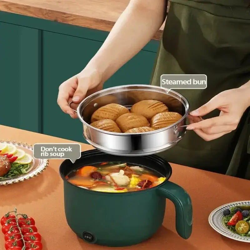 Compact 1.5L multifunctional electric pot steaming buns and cooking soup simultaneously, perfect for home kitchen use and daily cooking needs.