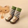 Green monkey baby shoes with striped design