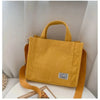 Yellow women's corduroy bag with handles and strap