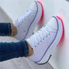 White women's casual shoes with pink sole