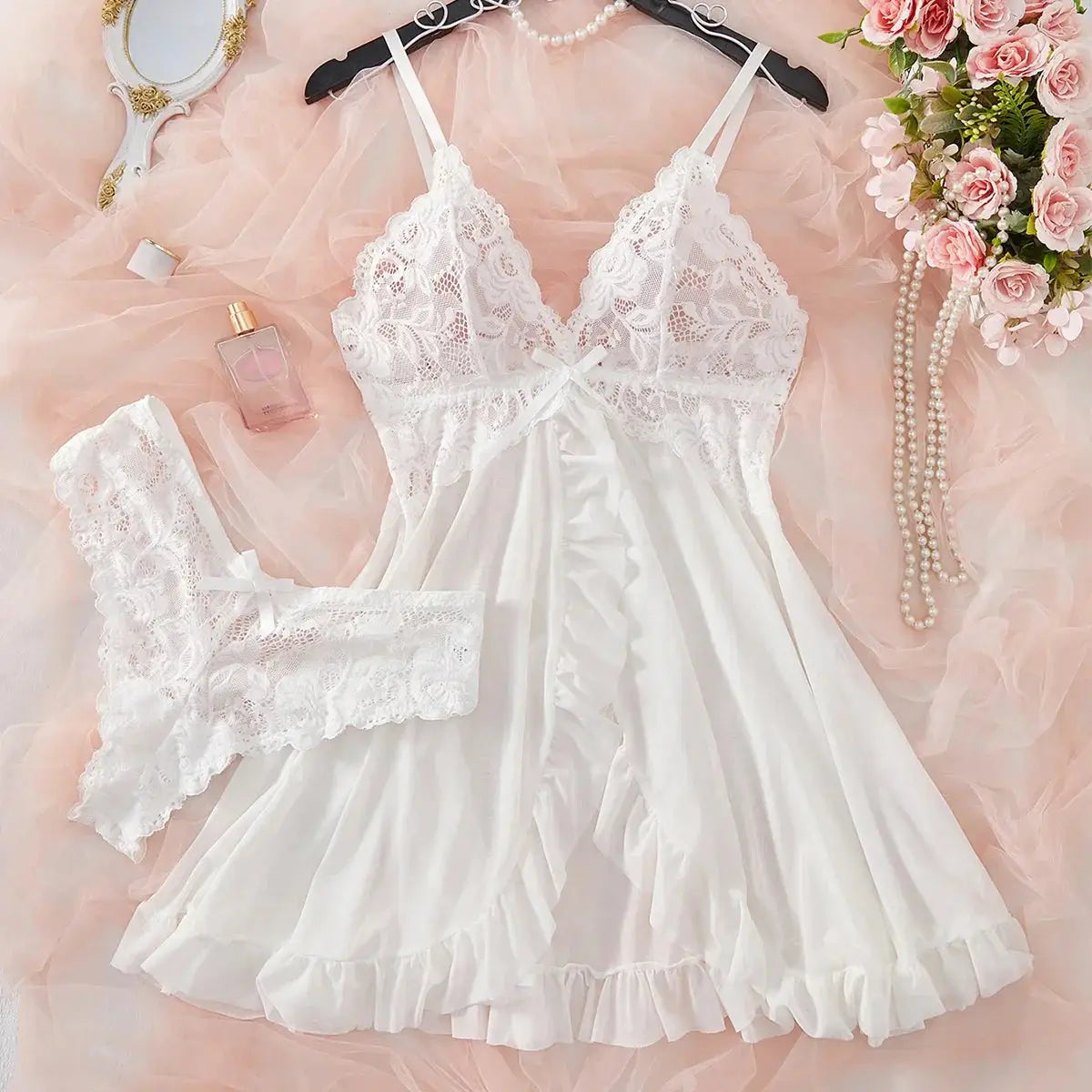 Detailed view of white lace V-neck full slip nightdress with ruffled trim, part of a soft and feminine women's sleepwear set.
