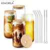 Assorted glass tumblers with drinks, bamboo lids, and straws