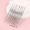 Stainless steel acne tools on pink background