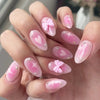 Pink French nails with heart and bow designs