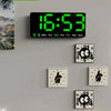 Green LED digital alarm clock with date display on wall