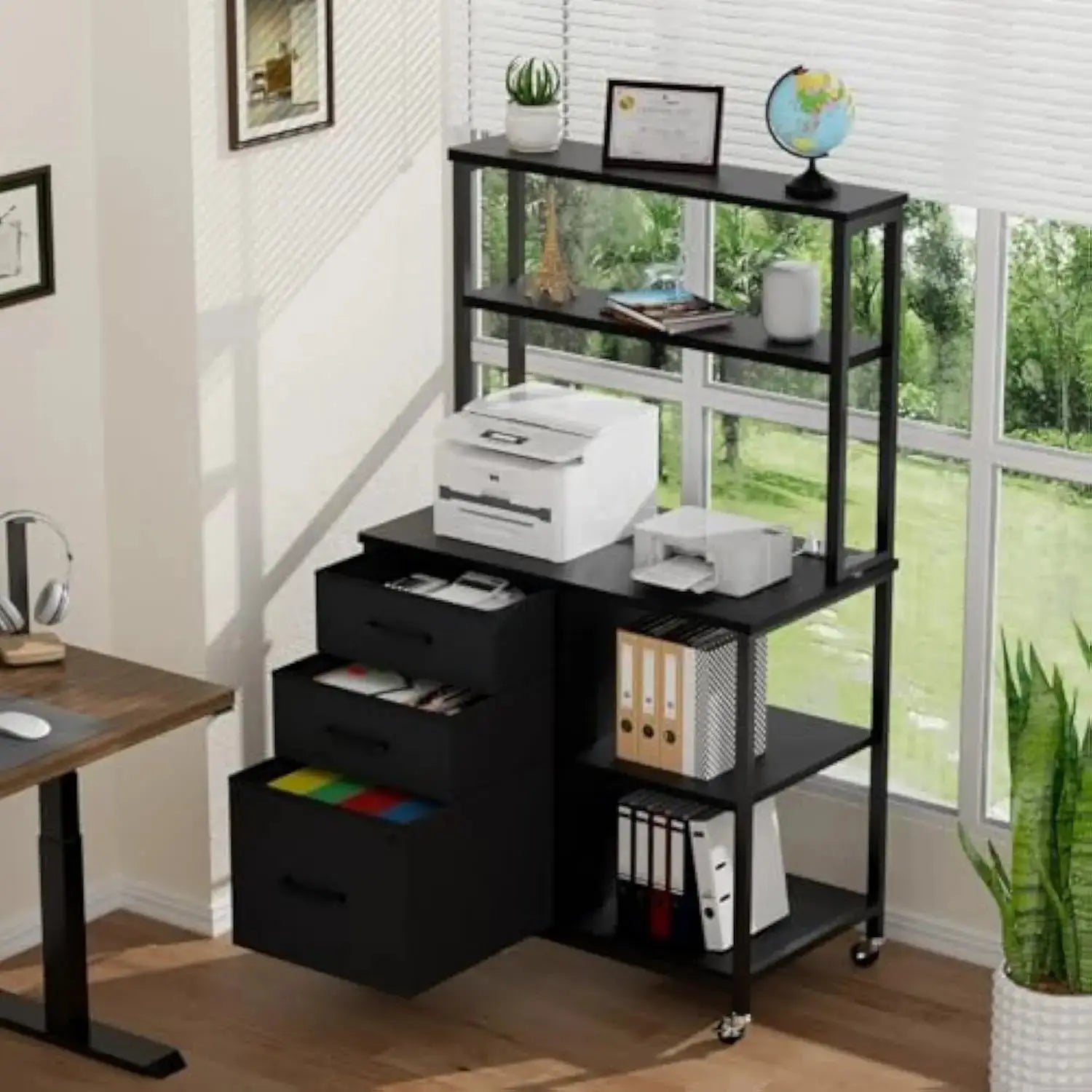 Black filing cabinet with wheels for home office featuring drawers, open shelves, and a mobile printer stand setup near a window.