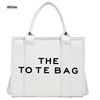 White tote bag featuring bold text design