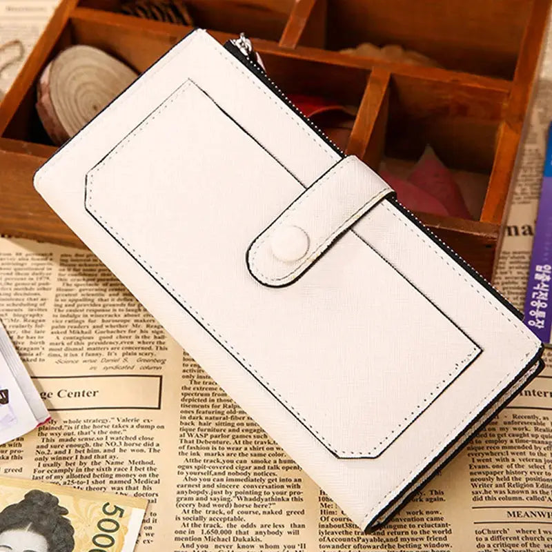 Beige women's PU leather bifold long wallet with buckle closure and zippered pocket, styled on a vintage newspaper background.
