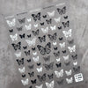 Black and white butterfly nail art stickers on gray sheet