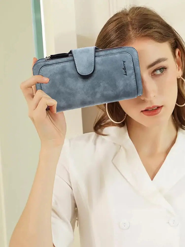 Model holding a blue women's long trifold wallet with large capacity, showcasing its stylish and functional design.