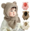 Baby wearing brown bear ear winter hat