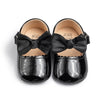 Black patent baby shoes with large bow