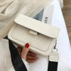 White faux leather crossbody bag with black strap