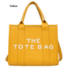 Yellow tote bag featuring stylish text design