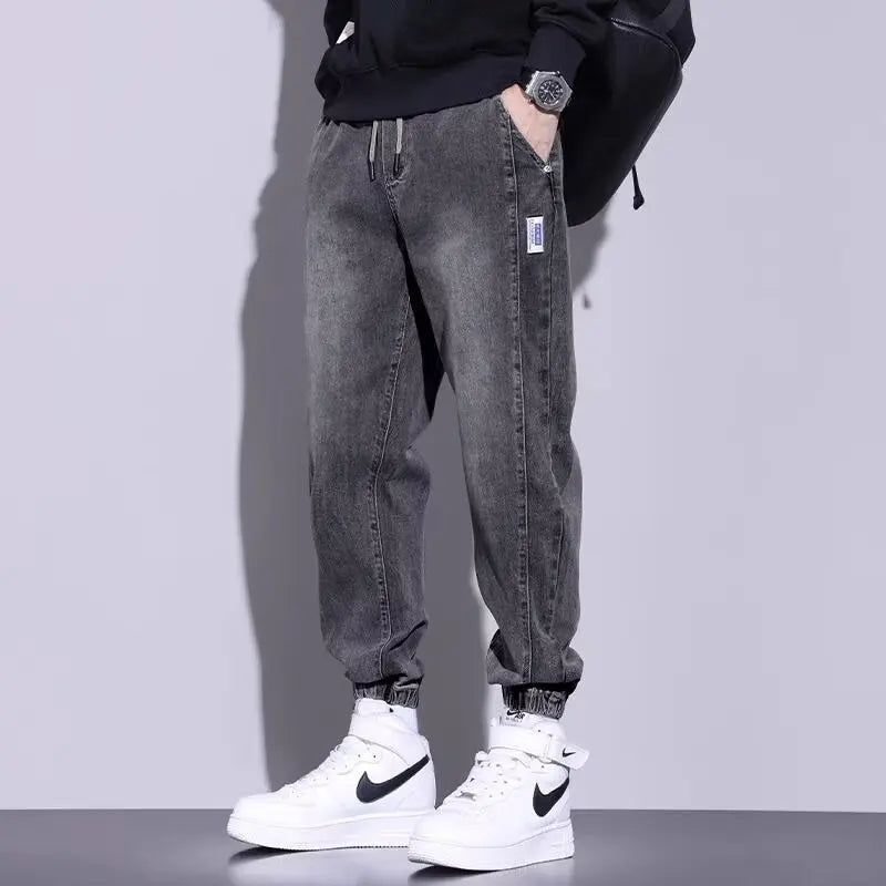 Gray casual cargo pants for men with elastic cuffs and drawstring.