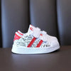 White kids' shoes with red stripes, non-slip design