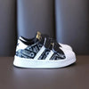 Black kids' shoes with white stripes, non-slip design