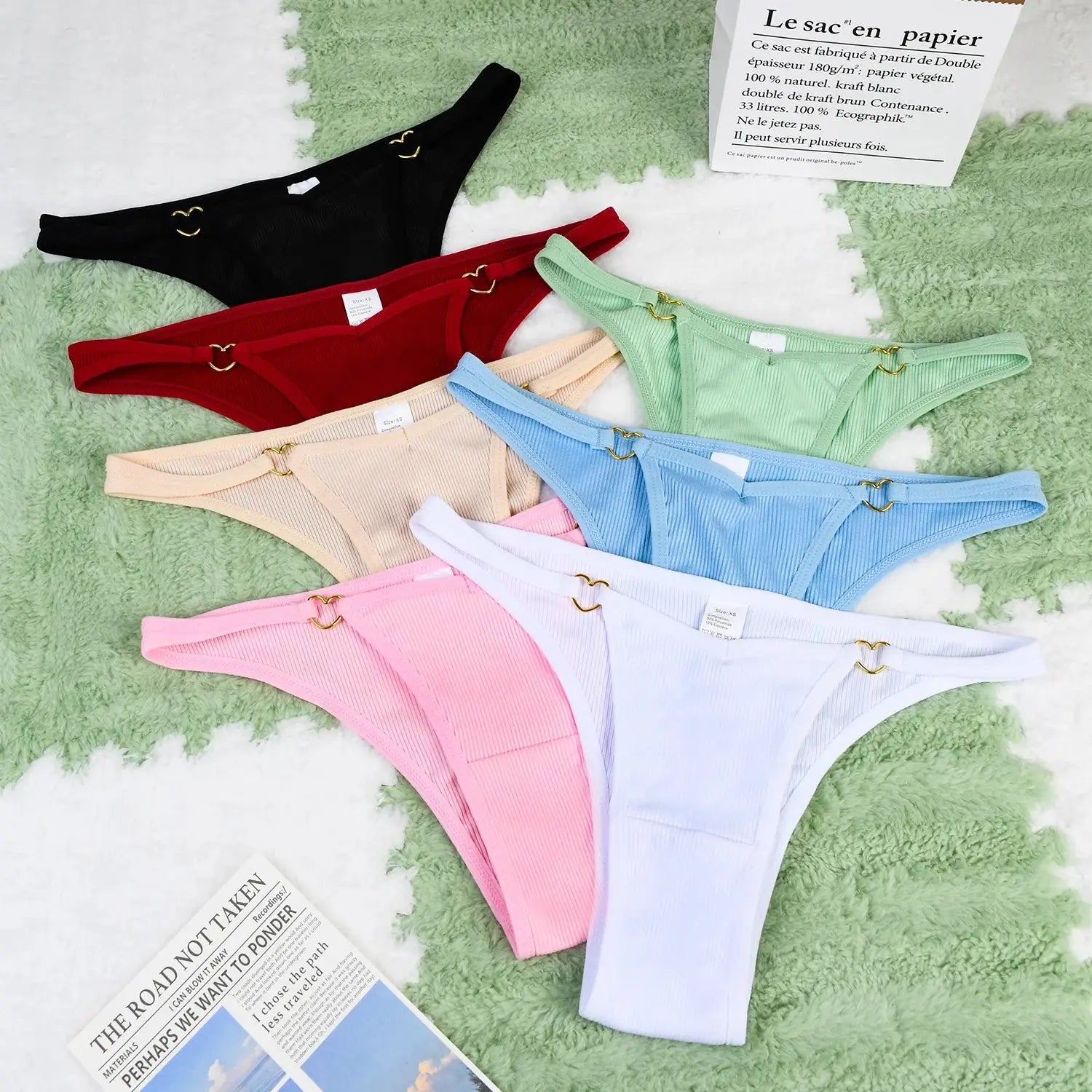 Full display of 7-piece ribbed cotton thong set for women with heart ring accents, soft breathable fabric in multiple colors.