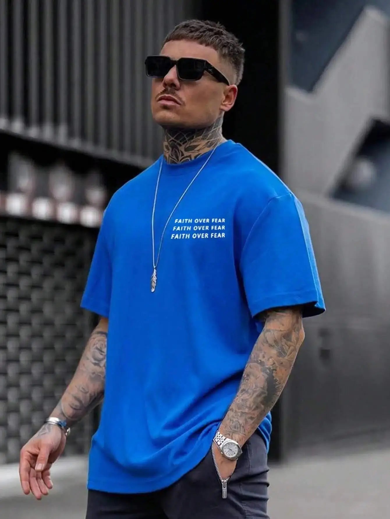 Bright blue cotton t-shirt for men with 'Faith Over Fear' text, styled for a bold look.