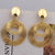 Trendy gold dangle earrings with round design