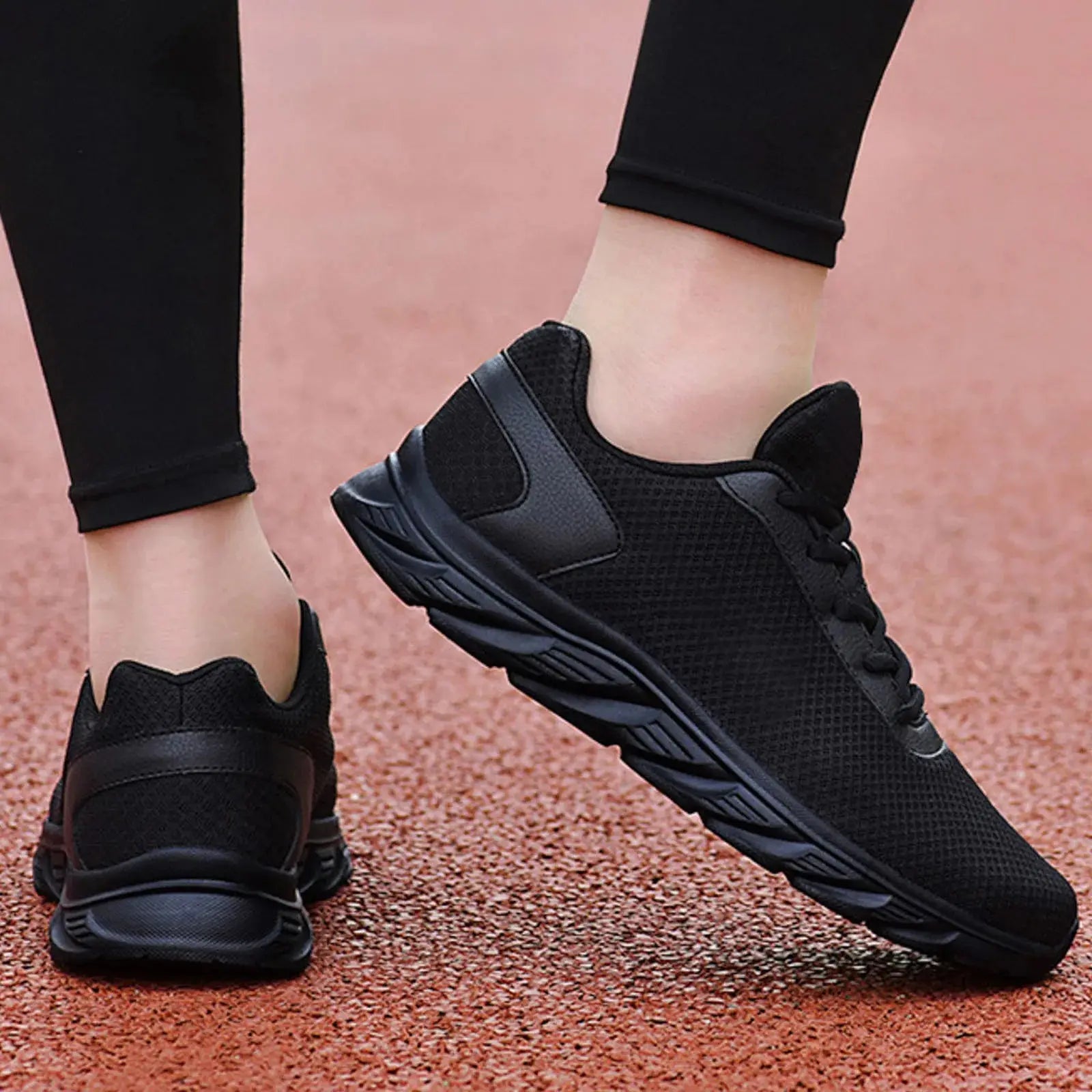Black men's leather sneakers with breathable mesh and cushioned sole, designed for comfort and summer athletic use.