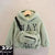 Green kids' hoodie with 'WAY' lettering and matching bag.