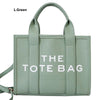 Light green tote bag with bold text design