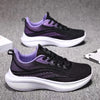 Black and purple casual running shoes on gray surface