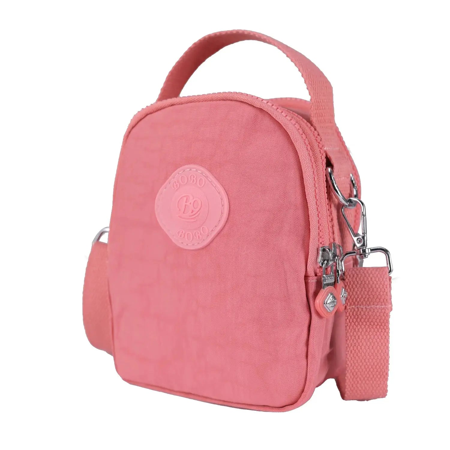 Close-up of pink waterproof crossbody bag with top handle and metal hardware, ideal for casual and travel use.
