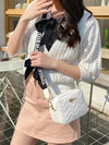 Woman with white square shoulder bag and stylish outfit