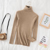 Brown women's turtleneck sweater on bed