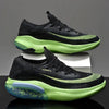 Black and green sports shoes for men and women with breathable design.