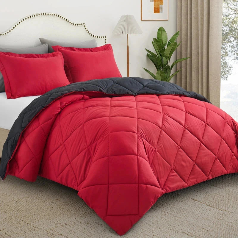 Reversible microfiber comforter set with pillow shams in red and black, featuring quilted stitching and brushed texture for all-season bedding.