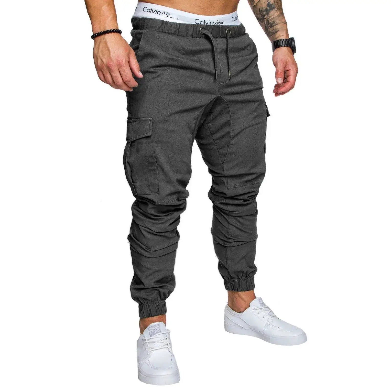 Dark gray men’s drawstring cargo pants with ankle cuffs and pleated front, suitable for spring and summer outfits.