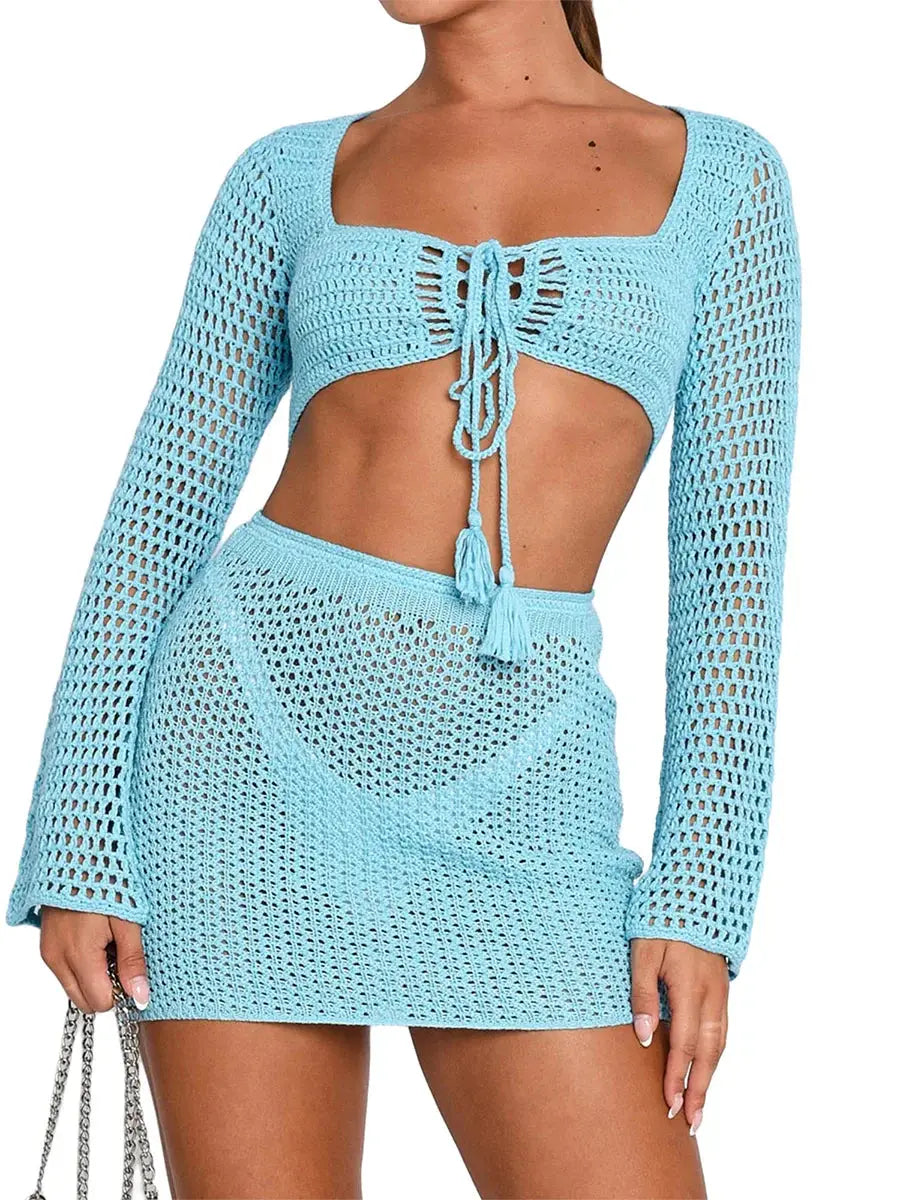 Womens 2-piece beachwear set featuring a knit tie-front long sleeve cover-up and matching mini sarong skirt in light blue. Ideal summer outfit for beachwear.