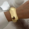 Gold vintage wide bracelet on wrist